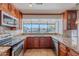 The kitchen features stainless steel appliances, granite countertops, and beautiful cabinets and a view of the pool at 5539 E Dahlia Dr, Scottsdale, AZ 85254