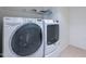 Laundry room featuring white washer and dryer with overhead shelving for storage at 5539 E Dahlia Dr, Scottsdale, AZ 85254