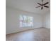 Comfortable living room with tile flooring, neutral walls, ceiling fan, and natural light from a large window at 5539 E Dahlia Dr, Scottsdale, AZ 85254
