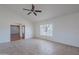 Bright and airy living room with neutral tile floors, ceiling fan, and a large window offering natural light at 5539 E Dahlia Dr, Scottsdale, AZ 85254