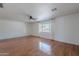 Bright living room with hardwood floors, a ceiling fan, and a large window bringing in natural light at 5539 E Dahlia Dr, Scottsdale, AZ 85254