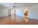 Spacious living room with a ceiling fan, hardwood floors, and an entrance leading to a bathroom at 5539 E Dahlia Dr, Scottsdale, AZ 85254