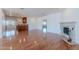 Spacious living room with fireplace, wood floors, seamlessly connected to the wet bar and other living spaces at 5539 E Dahlia Dr, Scottsdale, AZ 85254