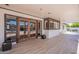 Covered patio with tiled floor and wood framed doors leading to the backyard at 5539 E Dahlia Dr, Scottsdale, AZ 85254