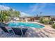 Inviting backyard pool with lounge chairs, mature trees, and well-maintained landscaping at 5539 E Dahlia Dr, Scottsdale, AZ 85254