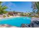 Backyard pool with serene setting, mature landscaping, and comfortable lounge chairs at 5539 E Dahlia Dr, Scottsdale, AZ 85254