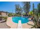 Backyard pool with diving board, lounge chairs, mature landscaping, and blue sky at 5539 E Dahlia Dr, Scottsdale, AZ 85254