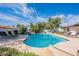 Sparkling blue pool featuring a rock feature and manicured landscaping at 5539 E Dahlia Dr, Scottsdale, AZ 85254