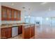 This wet bar features custom cabinetry, granite counters, a mini refrigerator, and pendant lighting at 5539 E Dahlia Dr, Scottsdale, AZ 85254