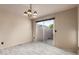 Bright dining room with tile floors, a modern chandelier, and a sliding glass door to the backyard at 6902 W Devonshire Ave # 1280, Phoenix, AZ 85033