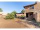 Exterior view of a two-story townhome featuring desert landscaping and a covered front porch at 6902 W Devonshire Ave # 1280, Phoenix, AZ 85033