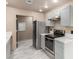 Modern kitchen with stainless steel appliances, white countertops, and updated cabinets at 6902 W Devonshire Ave # 1280, Phoenix, AZ 85033