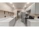 Modern kitchen with stainless steel appliances, white countertops, and updated cabinets at 6902 W Devonshire Ave # 1280, Phoenix, AZ 85033