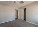 A spacious bedroom offers soft carpeting, a ceiling fan, and a large closet with folding doors at 717 W Chilton St, Chandler, AZ 85225