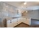 Kitchen with white cabinets, wood look flooring, stone countertops and open to living area at 717 W Chilton St, Chandler, AZ 85225