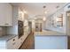 Modern kitchen featuring white cabinets, granite countertops, and stainless steel appliances at 717 W Chilton St, Chandler, AZ 85225