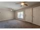 Bright living room features carpeted floors, neutral walls, and large windows for natural light and comfort at 717 W Chilton St, Chandler, AZ 85225