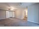 Large living room featuring new carpet, with doors to a closet, and a view of the bathroom at 717 W Chilton St, Chandler, AZ 85225