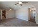 Living room boasts carpeted floors, neutral walls, ceiling fans, and bright windows with open access to other rooms at 717 W Chilton St, Chandler, AZ 85225