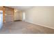 Spacious living room with carpeted floors, neutral walls, a wooden accent wall and open access to other rooms at 717 W Chilton St, Chandler, AZ 85225
