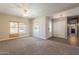 Bright living room with neutral walls, carpeted floor, ceiling fan and plentiful natural light from two large windows at 717 W Chilton St, Chandler, AZ 85225
