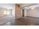 Open floor plan showcases a seamless blend of hardwood and carpet, enhanced by natural light from surrounding windows at 717 W Chilton St, Chandler, AZ 85225