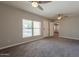 Living room features carpeted floors, neutral walls, bright windows, and open access to other rooms at 717 W Chilton St, Chandler, AZ 85225