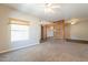 Bright living room featuring carpeted floor, neutral walls, wood accent wall and ceiling fan for enhanced comfort at 717 W Chilton St, Chandler, AZ 85225