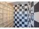 Stylish shower stall showcasing striking black and white checkered tile and multiple shower heads at 717 W Chilton St, Chandler, AZ 85225