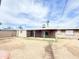 Large backyard featuring mature trees, a covered patio, sliding glass doors, and block wall fencing at 7202 N 36Th Ave, Phoenix, AZ 85051