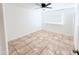 Bedroom featuring neutral tile floor, a window, and ceiling fan at 7202 N 36Th Ave, Phoenix, AZ 85051
