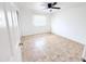 Clean bedroom featuring neutral tile floor, window, and ceiling fan at 7202 N 36Th Ave, Phoenix, AZ 85051
