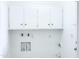 All-white laundry room with tiled floors and overhead cabinets at 7202 N 36Th Ave, Phoenix, AZ 85051