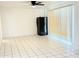 Bright living room featuring tiled floor, black refrigerator, and ceiling fan at 7202 N 36Th Ave, Phoenix, AZ 85051