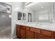 Bathroom features double sinks, spacious vanity, and a large mirror, with updated light fixtures at 7607 W Keim Dr, Glendale, AZ 85303