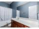Well-lit bathroom features a vanity with sink, a large mirror, and a shower-tub combination at 7607 W Keim Dr, Glendale, AZ 85303