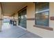 Covered patio featuring a concrete floor, sliding glass doors, and outdoor cooking setup at 7607 W Keim Dr, Glendale, AZ 85303