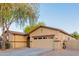 View of the front of a single-story home with a two-car garage and manicured yard at 7607 W Keim Dr, Glendale, AZ 85303