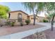 Single-story home showcasing desert landscaping, a two-car garage, and charming curb appeal at 7607 W Keim Dr, Glendale, AZ 85303