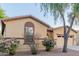 Close up of a front lawn and single-story home with desert landscaping and neutral tones at 7607 W Keim Dr, Glendale, AZ 85303