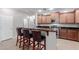 Kitchen island features a breakfast bar, granite countertops, stainless steel appliances, and ample cabinet space at 7607 W Keim Dr, Glendale, AZ 85303