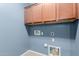 Convenient laundry room area with overhead cabinets and appliance hookups for easy laundry at 7607 W Keim Dr, Glendale, AZ 85303