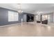 Spacious living room with large tile flooring, chandelier, media center, and a ceiling fan at 7607 W Keim Dr, Glendale, AZ 85303