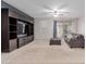 Comfortable living room featuring a large media center, a gray sofa, and a ceiling fan at 7607 W Keim Dr, Glendale, AZ 85303