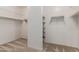 Spacious walk-in closet with shelving and carpeted flooring for ample storage in a clean design at 7607 W Keim Dr, Glendale, AZ 85303