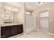 This bathroom features a single sink vanity, granite counters and a walk in shower at 7769 W Bonitos Dr, Phoenix, AZ 85035