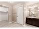 This bathroom features a single sink vanity, granite counters and a walk in closet at 7769 W Bonitos Dr, Phoenix, AZ 85035