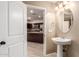 Powder room with a pedestal sink and a view into the kitchen at 7769 W Bonitos Dr, Phoenix, AZ 85035