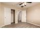 A cozy bedroom features light walls, wood-look flooring, and a closet with sliding doors at 7769 W Bonitos Dr, Phoenix, AZ 85035