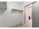 This walk in closet features shelving and a view of the bathroom at 7769 W Bonitos Dr, Phoenix, AZ 85035